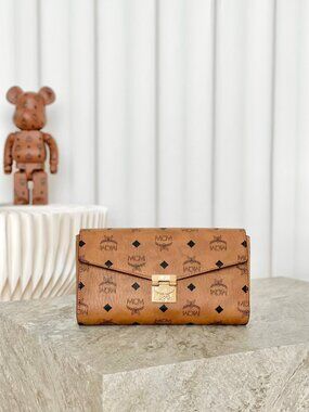 MCM Tan Monogram Clutch with Gold Accent